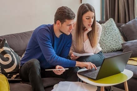 two people looking at mortgage balance on computer